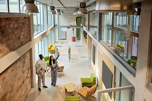 Real estate agent showing commercial office property to client
